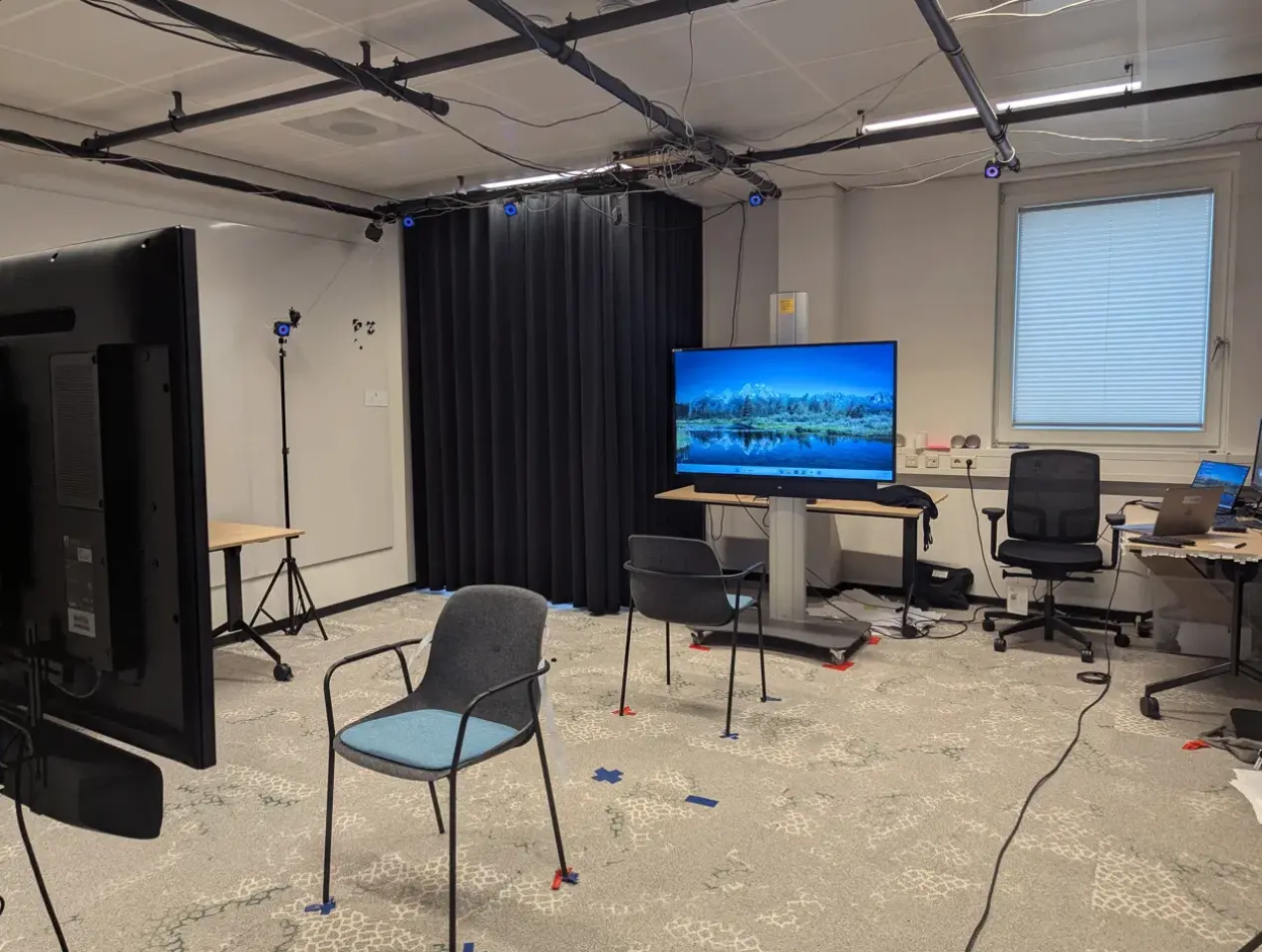 Interaction Lab at University of Twente with 14 OptiTrack cameras and black curtains
